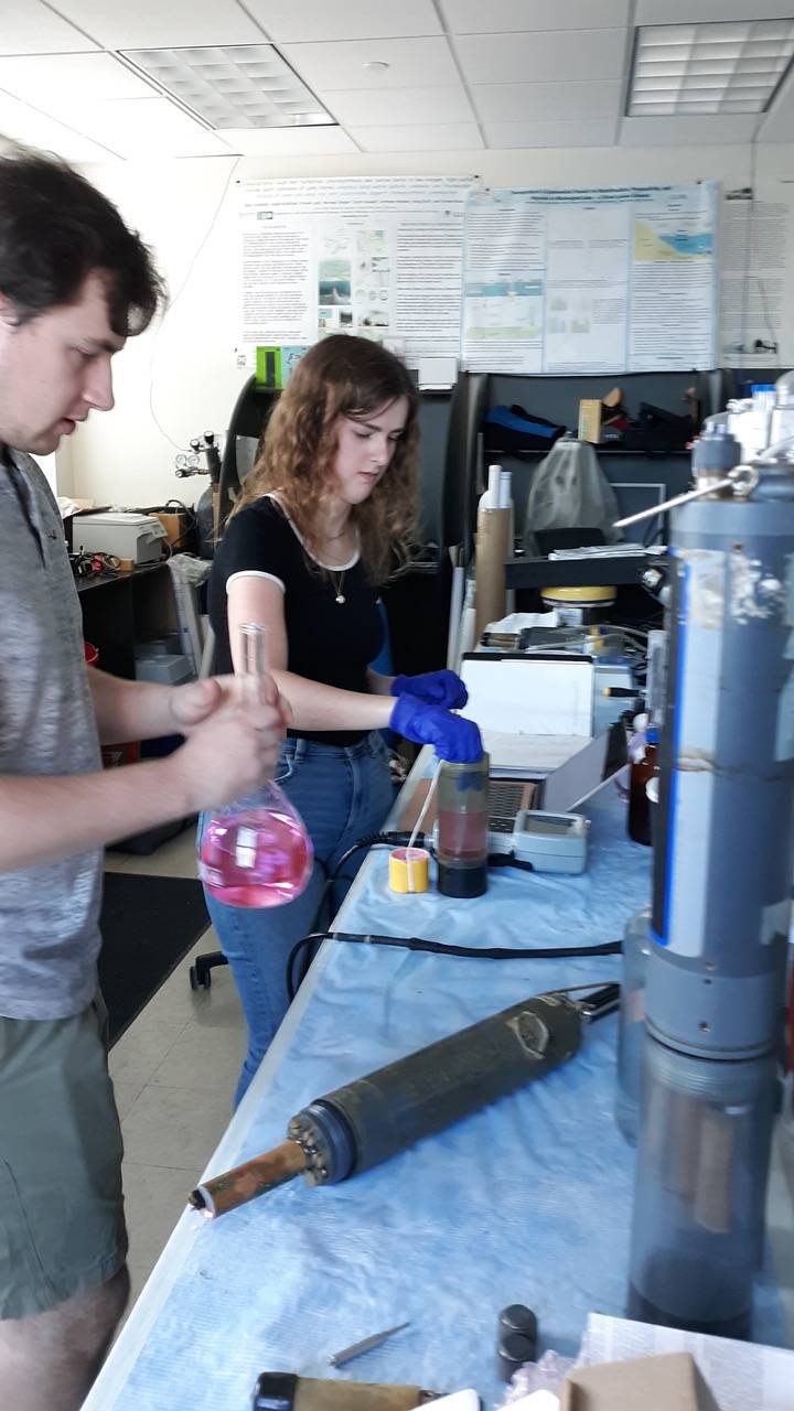 Nate pours calibrations solution and Jillian take solution temperature